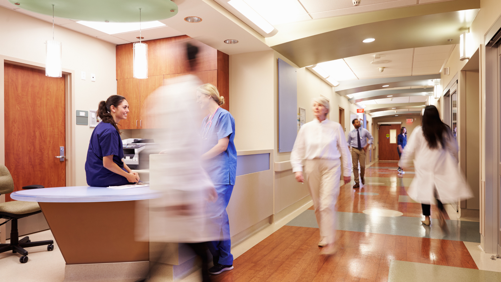 Medical professionals walking on a hospital floor