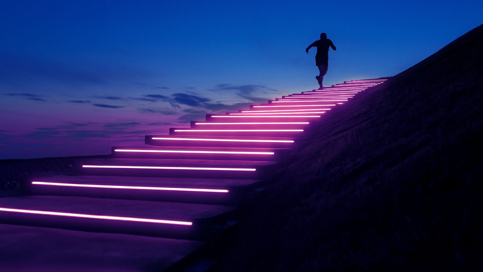 夜景の中、ネオンライトに照らされた階段を上る人物