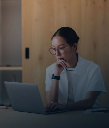 Person working on a laptop at a table.