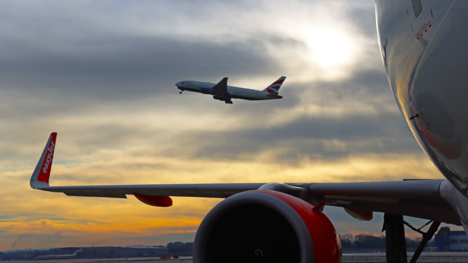 Airplanes on tarmac and taking off at the airport
