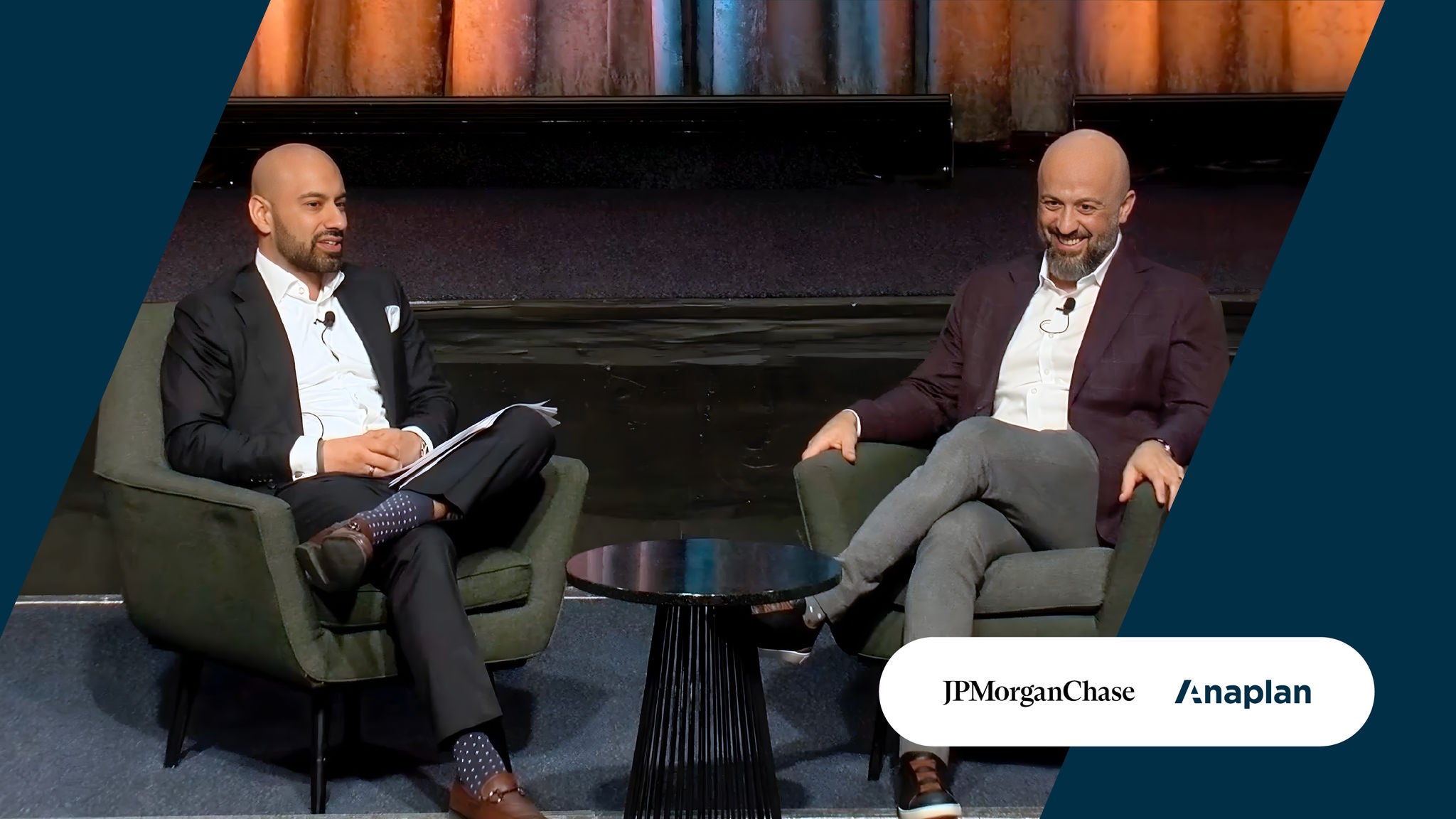Two panelists seated in armchairs engaged in a discussion, with JPMorgan Chase and Anaplan logos displayed in the corner.