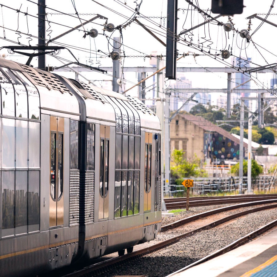 A train traveling along the tracks, showcasing its powerful engine and sleek design against a scenic backdrop.