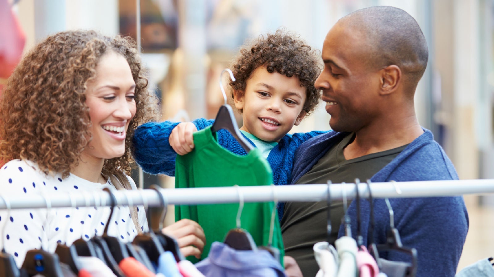 Family shopping for baby clothes