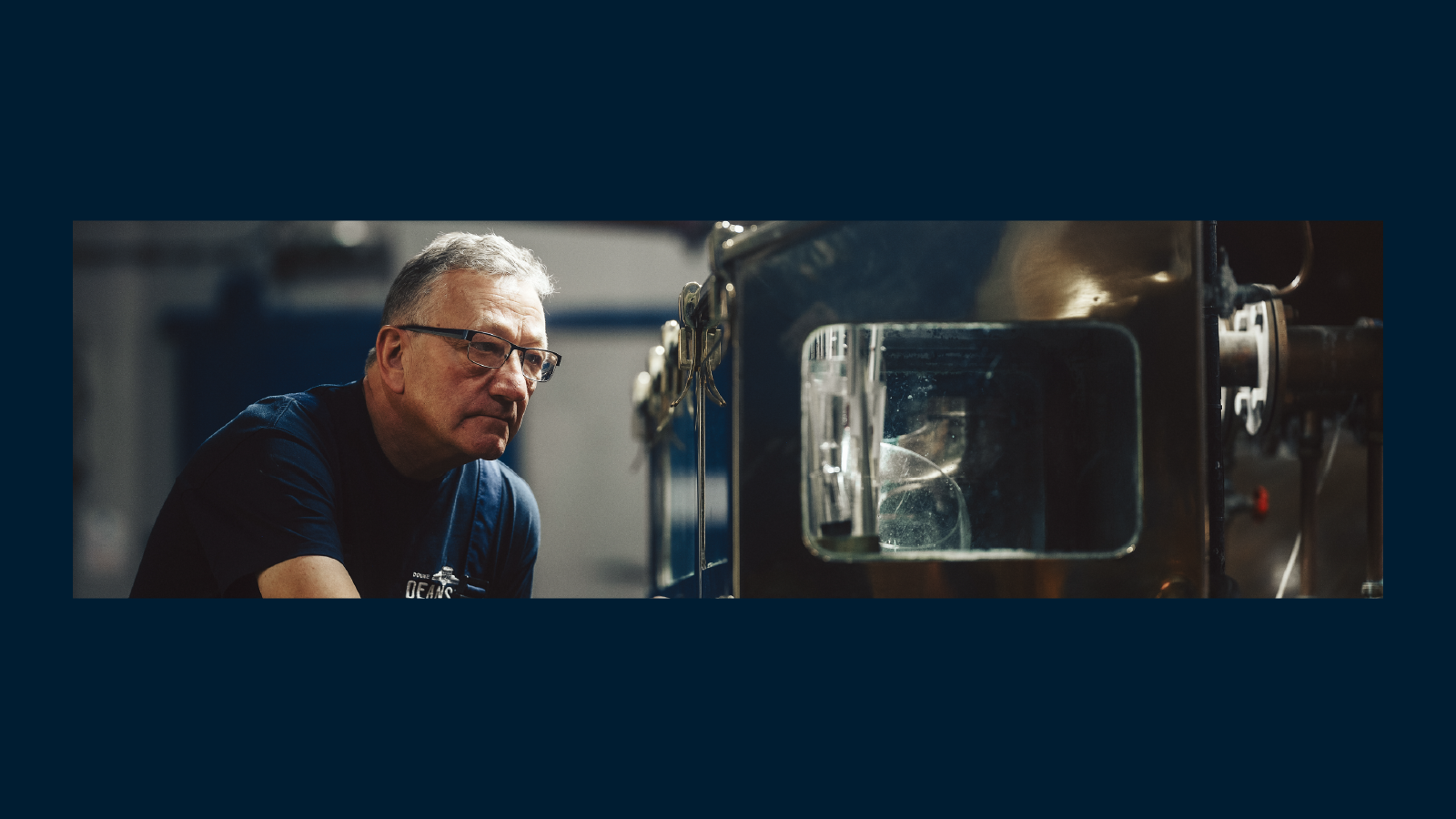 A professional in a data center adjusting server equipment while holding a laptop. The scene is illuminated with green lighting, giving a high-tech ambiance.