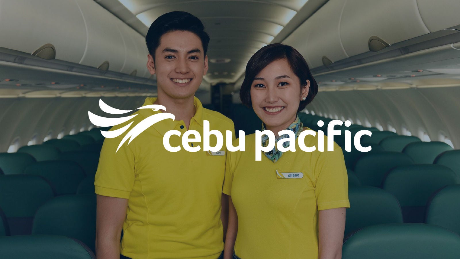 Two Cebu Pacific cabin crew members wearing yellow uniforms stand smiling inside an airplane cabin, with rows of green seats in the background and the Cebu Pacific logo displayed over the image.