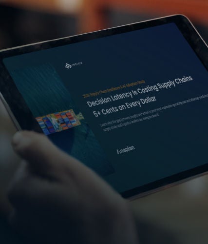 A person holding a tablet displaying a supply chain report, with a blurred indoor background.