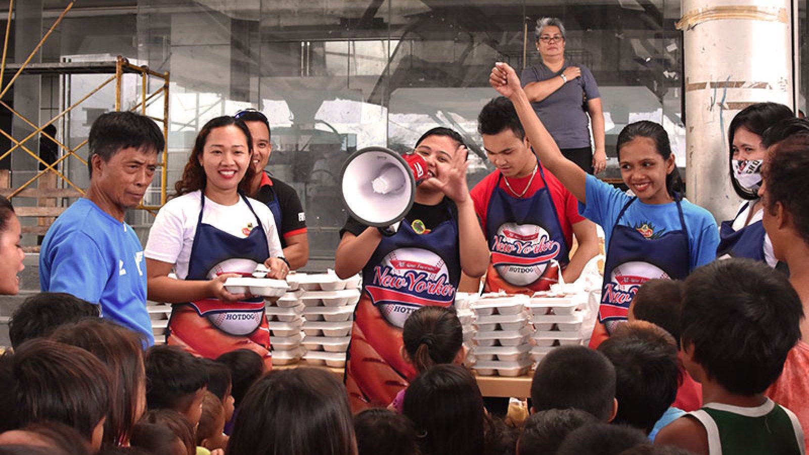 Virginia Food team members serve prepared meals to children during a community outreach event.