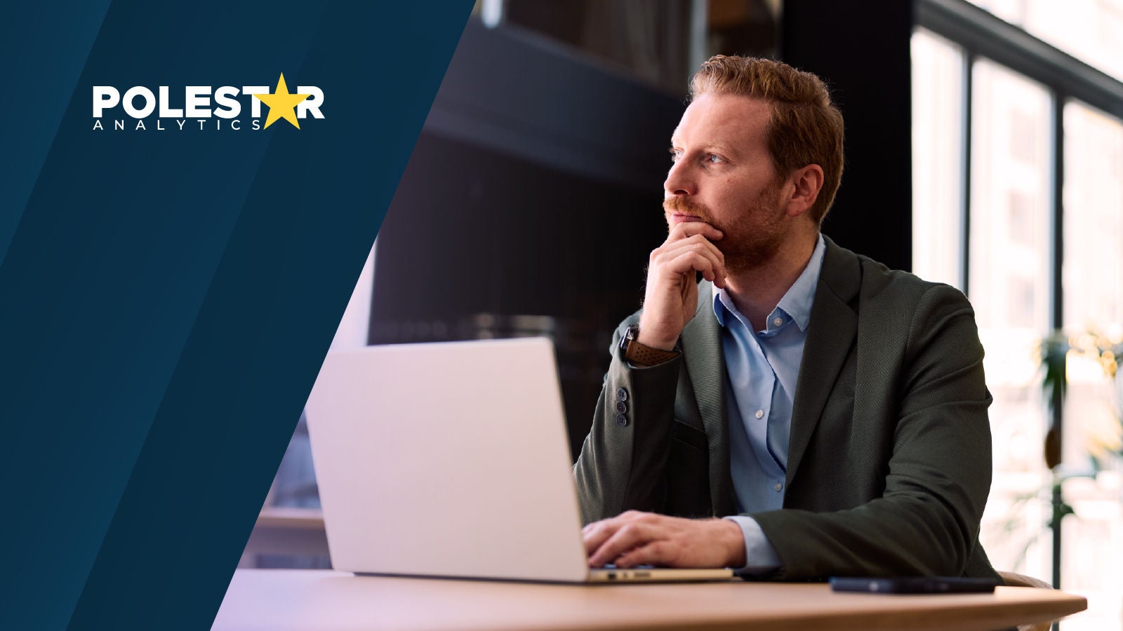 Business professional working on a laptop in an office, with the Polestar Analytics logo displayed.