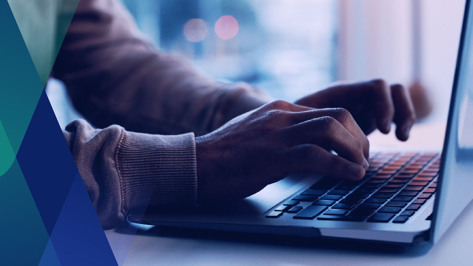 Close up image of hands typing on a laptop 