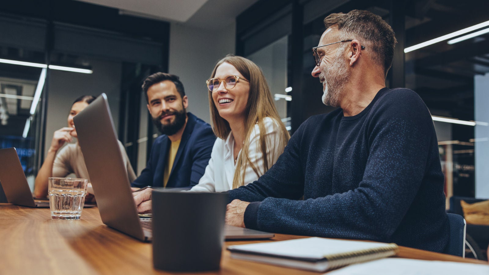 Marsh employees smiling in a meeting in a conference room