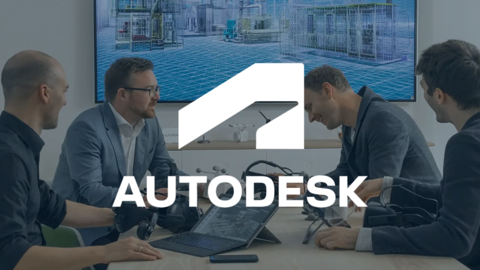 AUTODESK Logo displayed center. White logo over a scene of professionals in a meeting with VR equipment and architectural visuals.