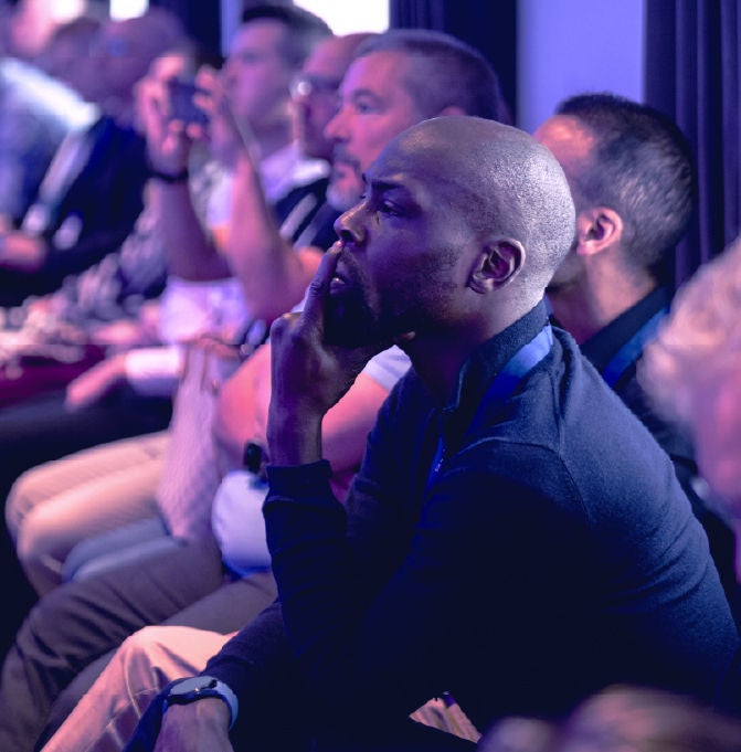 businessman pensively listening in on sales session