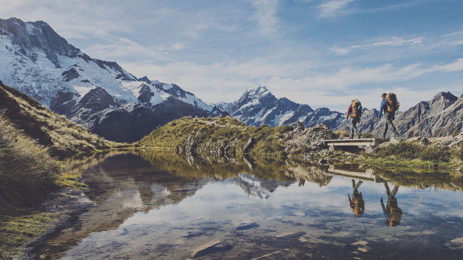 People hiking by a mountain
