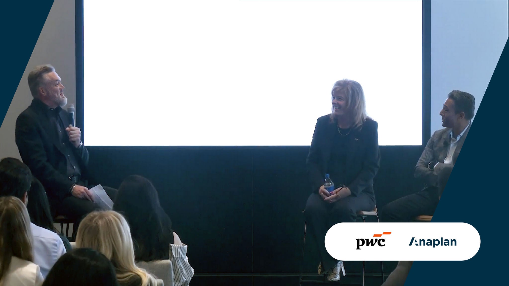 PwC and Anaplan Logos displayed bottom right. A panel discussion shows three speakers seated onstage before an audience, with one moderator holding a microphone while the others smile and engage in conversation.