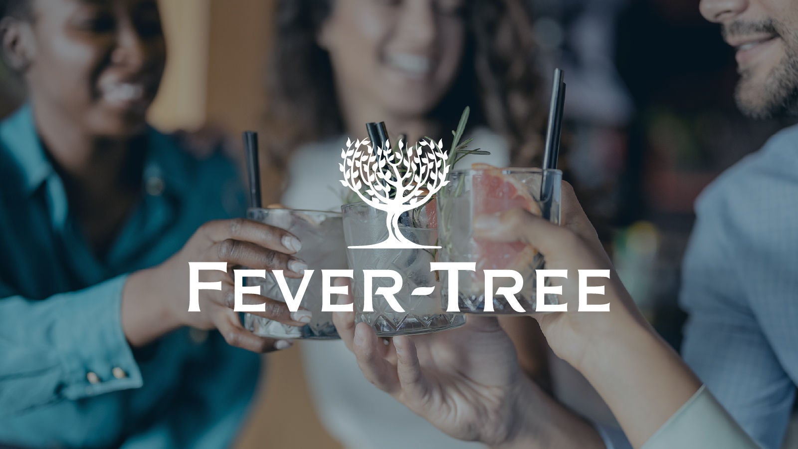 Fever-Tree logo displayed over a blurred background of people clinking cocktail glasses garnished with grapefruit and rosemary.