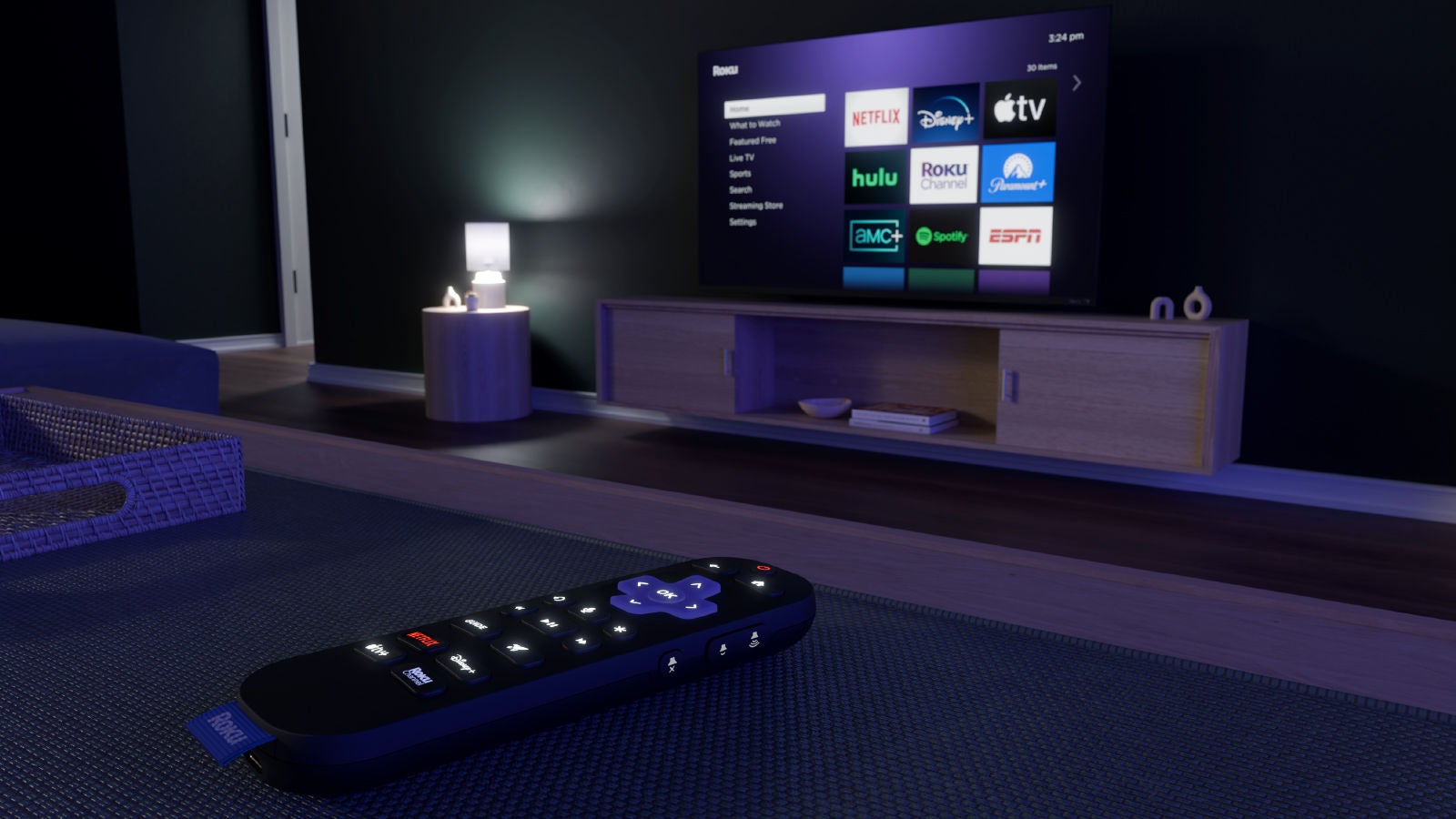Close-up view of a Roku remote control on a table with a television screen in the background showing streaming apps including Netflix, Disney+, Apple TV, Hulu, Roku Channel, Paramount+, ESPN, AMC+, and Spotify.