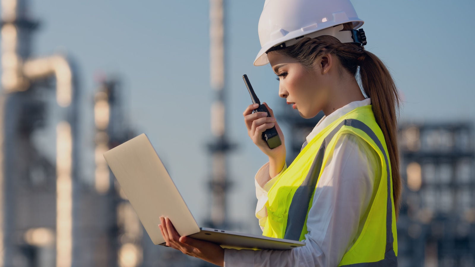 Denka employee talking on a walkie talkie
