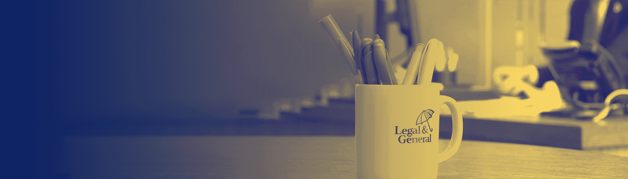 Desk with a Legal and General mug on it