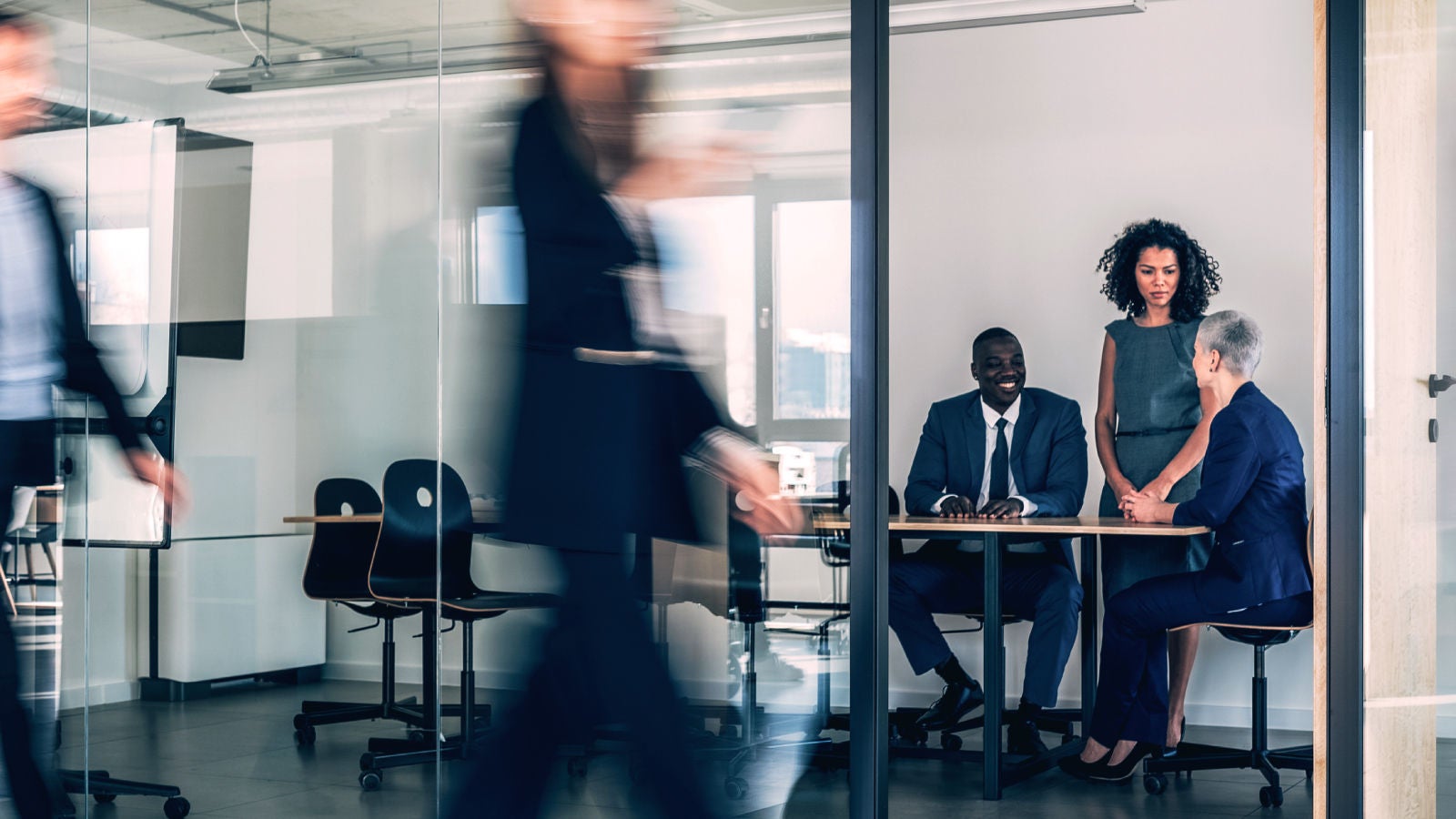 Coworkers walking and interacting in an office