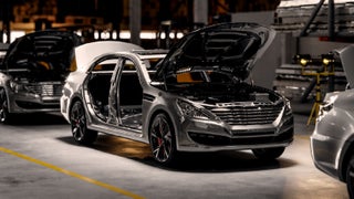 Featuring a car in assembly, presented in its skeletal form.