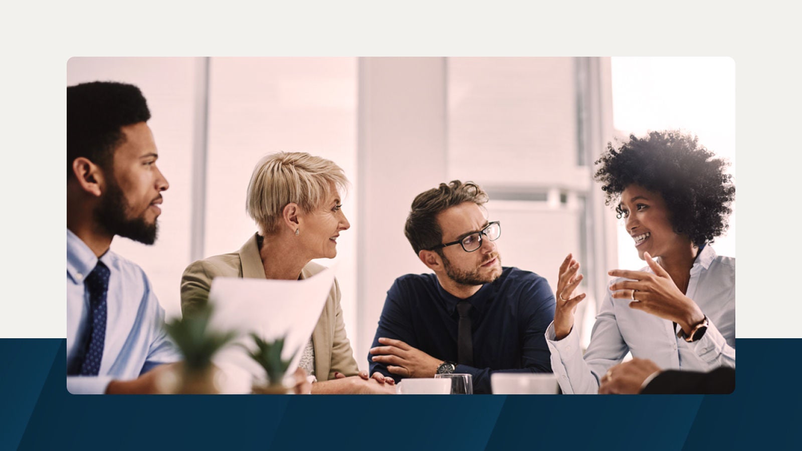 A diverse group of business professionals engaged in a discussion, emphasizing collaboration and security in enterprise management.