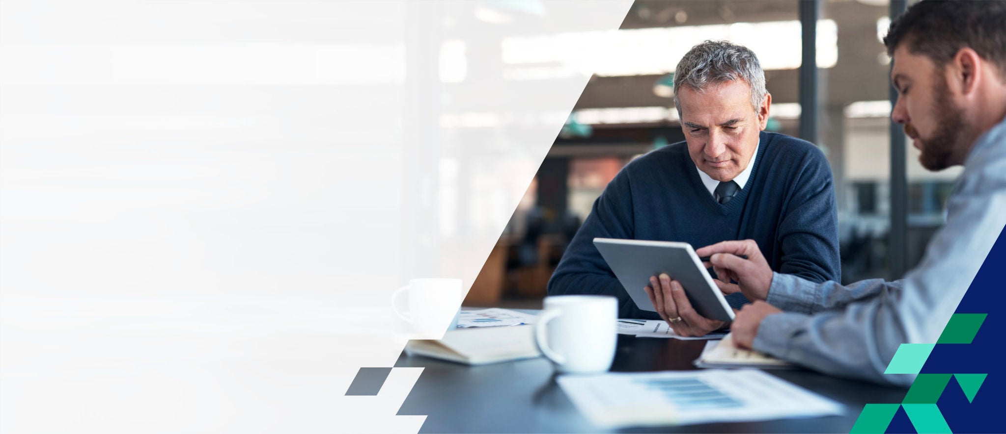 Two men looking at a tablet