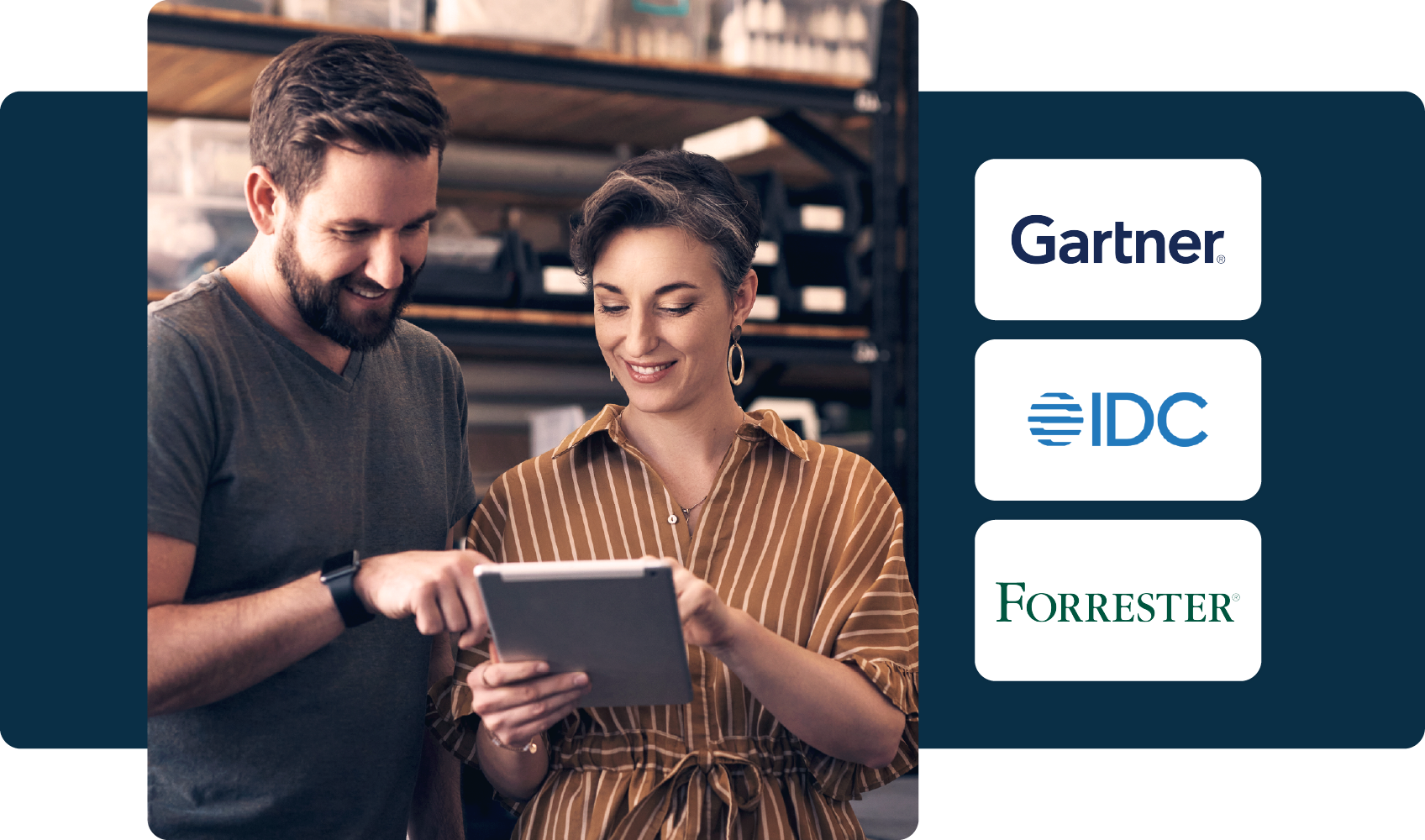 Two warehouse employees reviewing information on a tablet, with analyst logos (Gartner, IDC, Forrester) shown on the right.