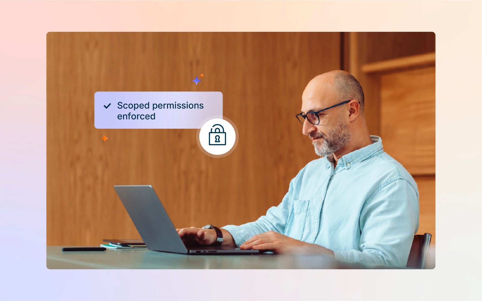 Businessman using a laptop with the message “Scoped permissions enforced” and a security lock icon.