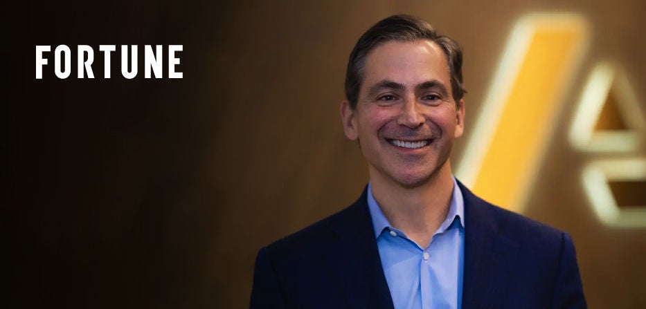 Fortune logo displayed beside Charlie Gottdiener in front of a blurred illuminated background.