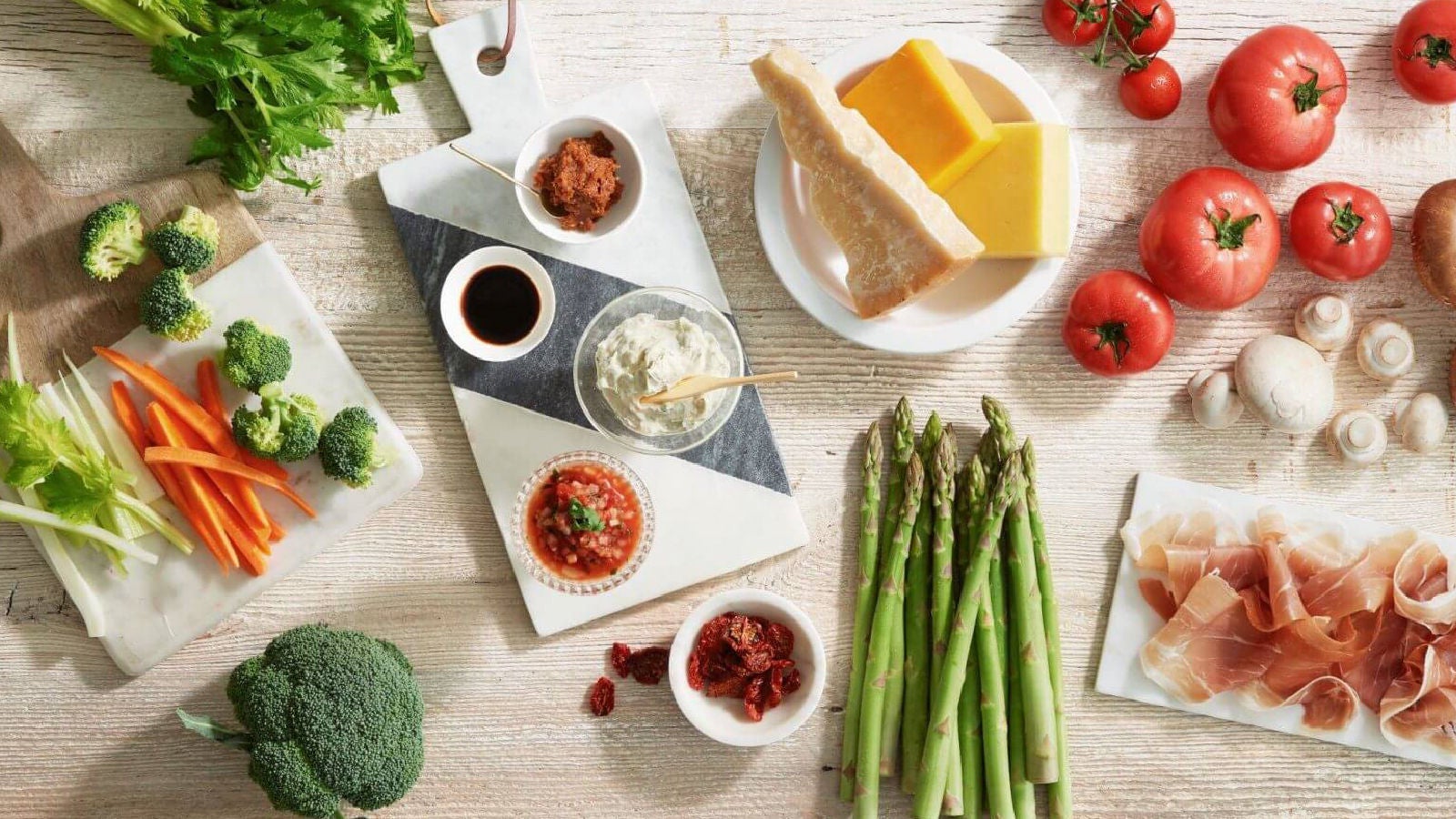 Overhead shot of produce, cheese, and dips