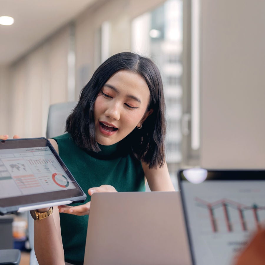 A woman presents graphics on her tablet