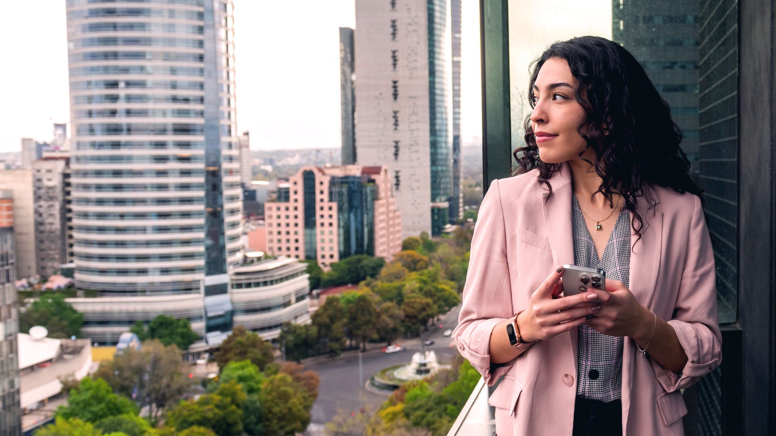 Woman on a balcony looking over a city
