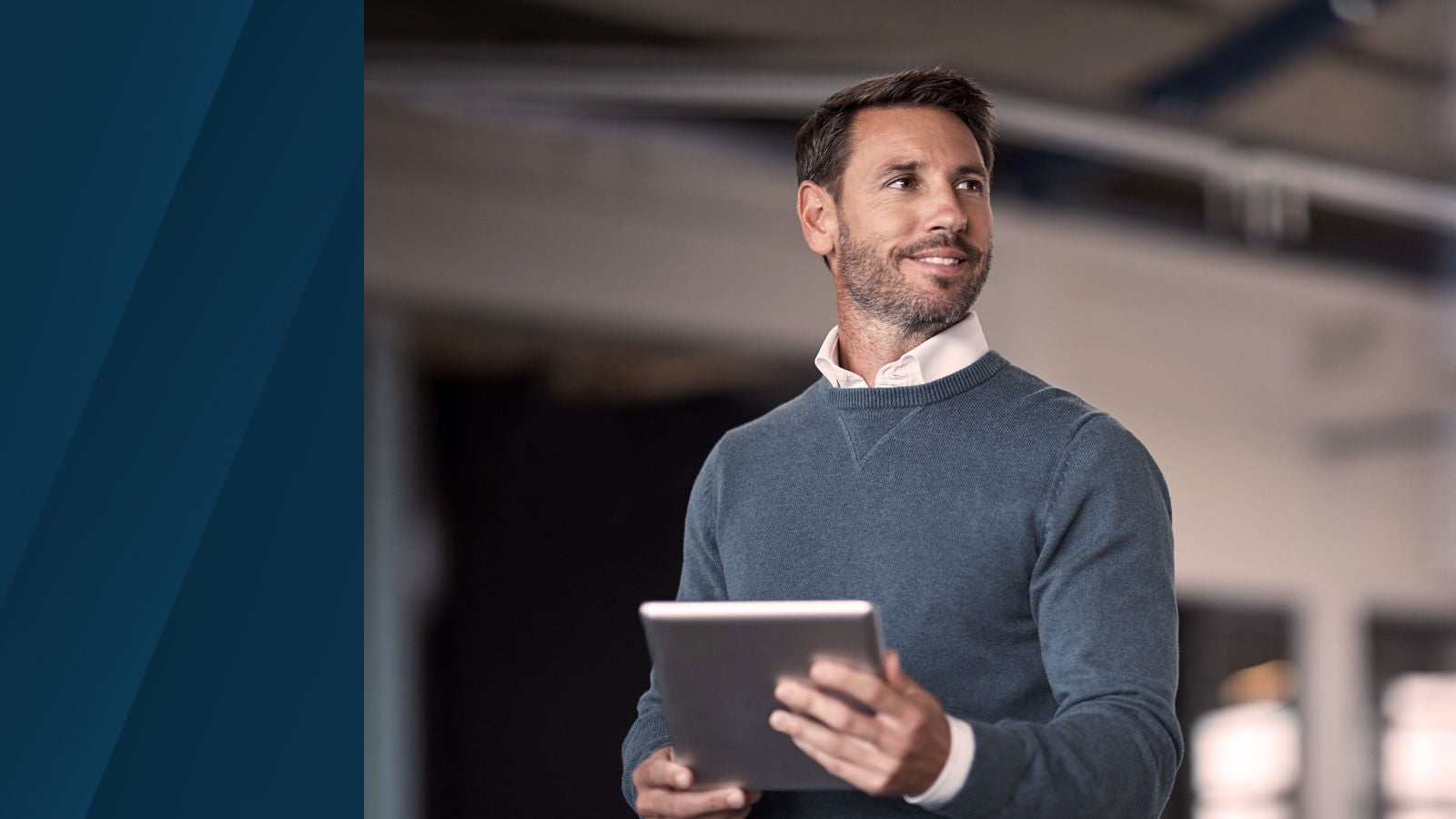 business professional holding a tablet in a modern office environment