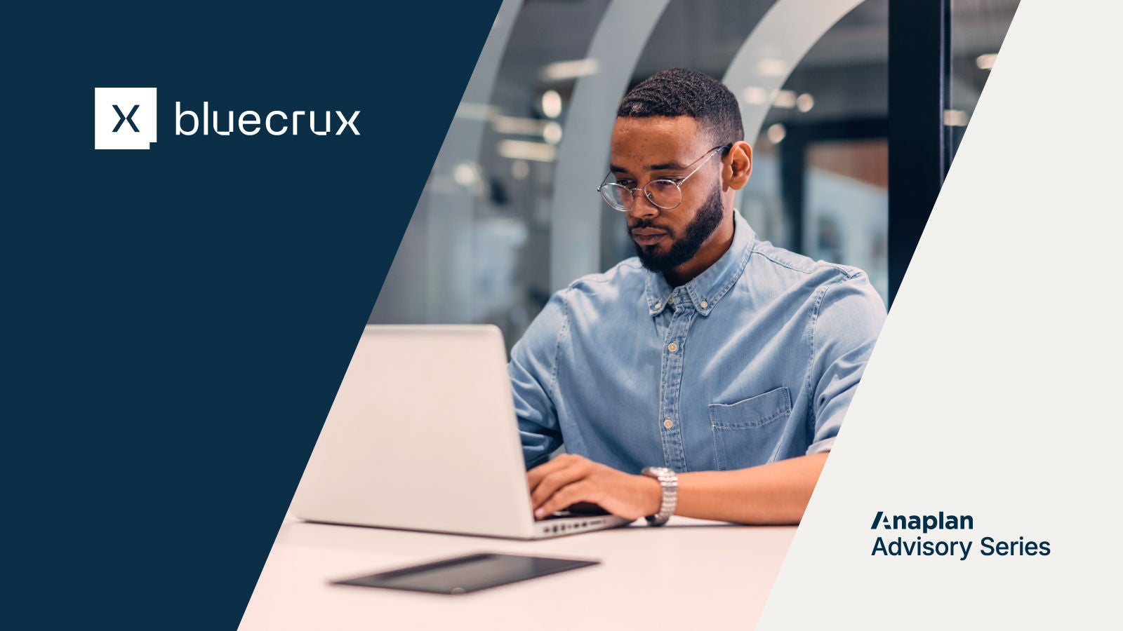 Bluecrux and Anaplan Advisory Series Logos displayed. A man in glasses and a denim shirt works on a laptop at a white desk.