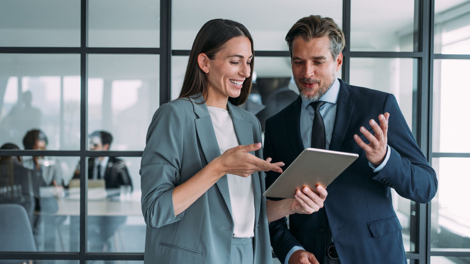 Deloitte employees looking at a tablet together