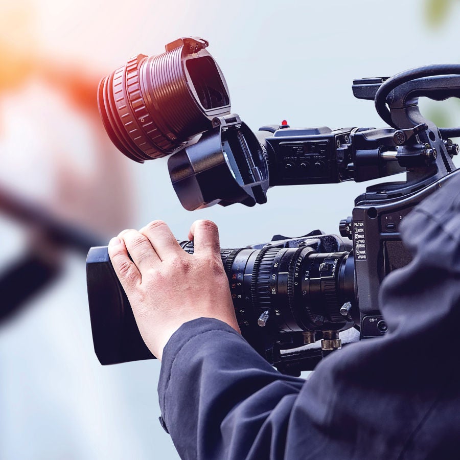 Man holding a professional video camera