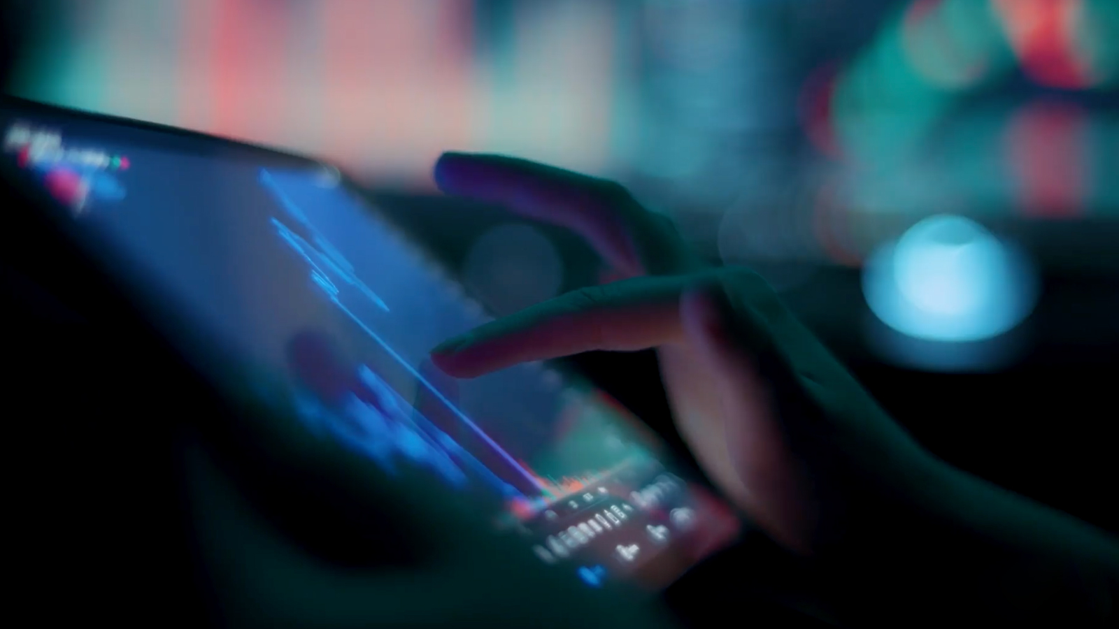Cassava Technologies Customer Story Illustrative Image 2 A close-up of a hand interacting with a touchscreen displaying financial or analytical data, with a blurred, colorful background.