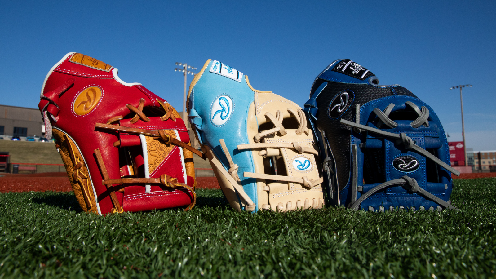 Rawlings Illustrative Photo two Three baseball mitts lined up on a field
