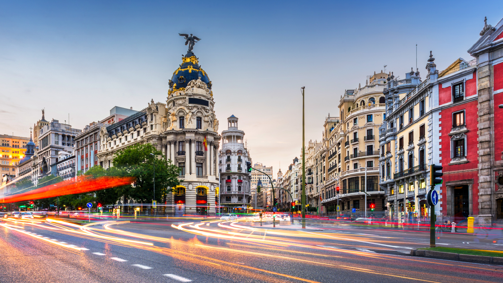 Anaplan event image for Connect 2025 Madrid. A vibrant cityscape featuring Gran Vía at dusk, with streaks of traffic lights and the iconic Metropolis Building in view.