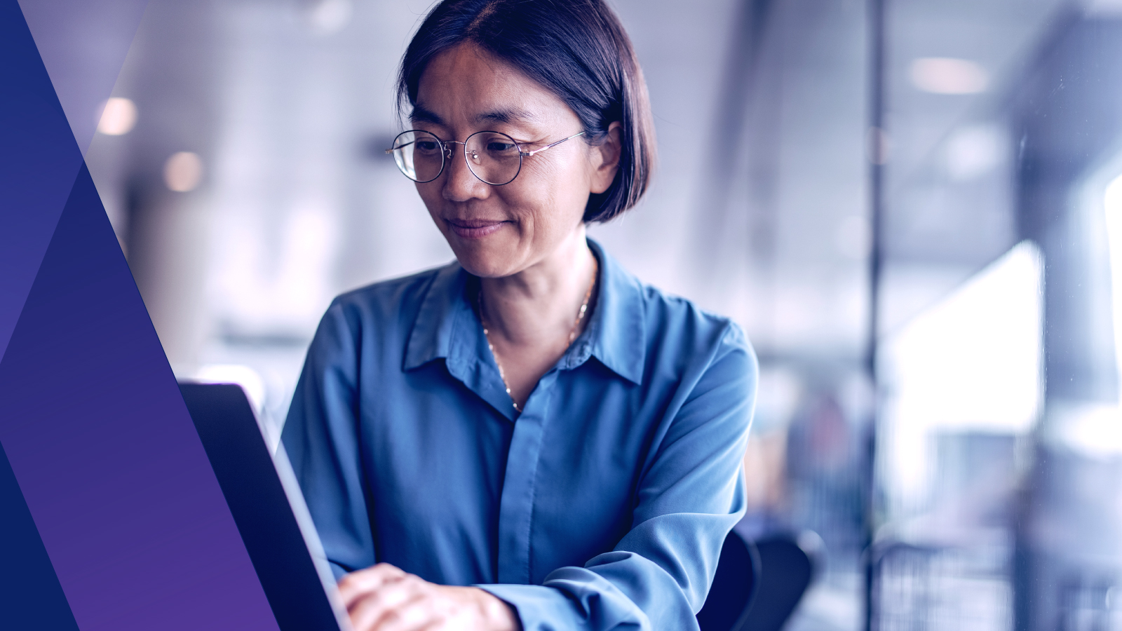 Woman smiling working on her laptop
