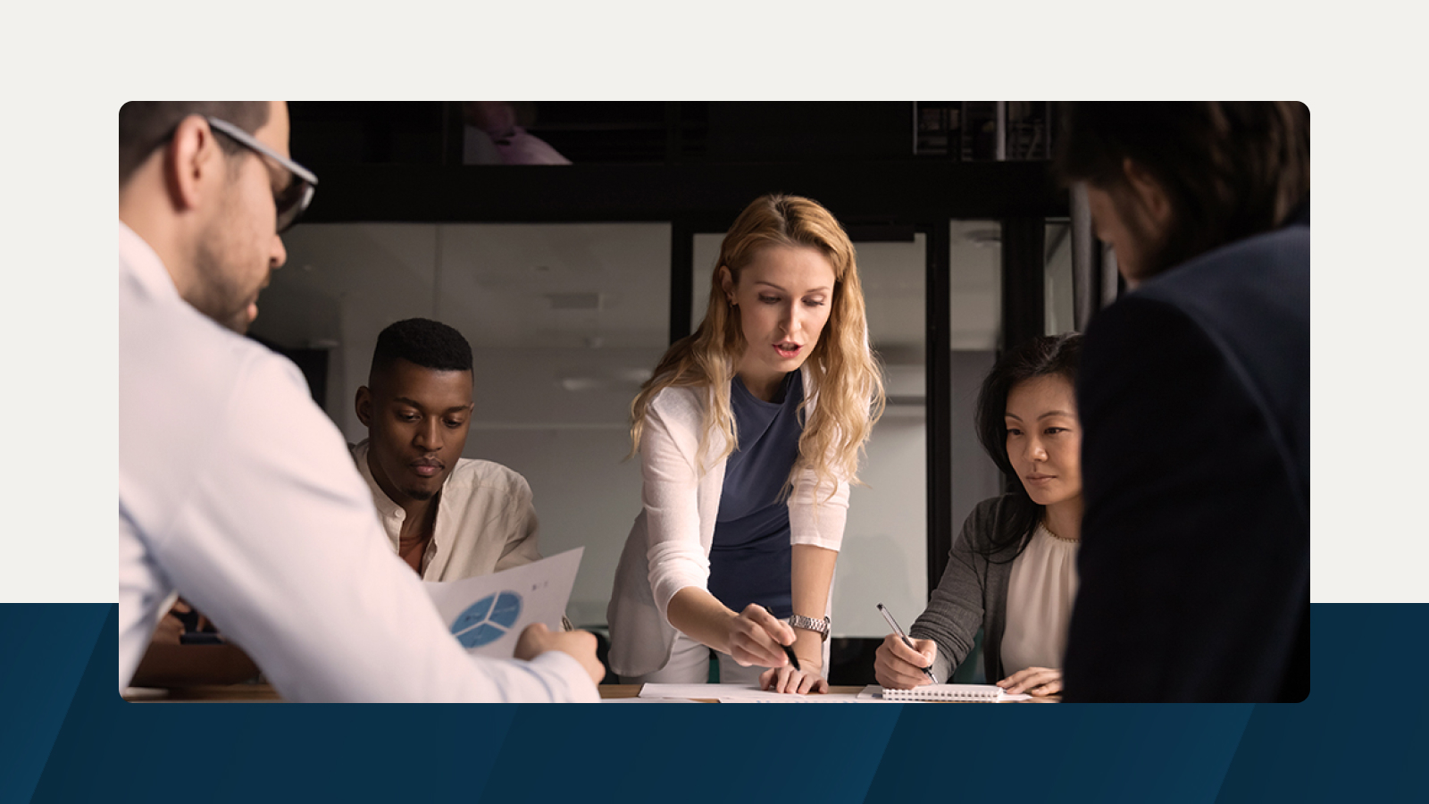 Anaplan solution brief on strategic workforce solutions for government. The text highlights improving government program efficacy through workforce planning, with an image of professionals collaborating over data and reports, symbolizing strategic decision-making.