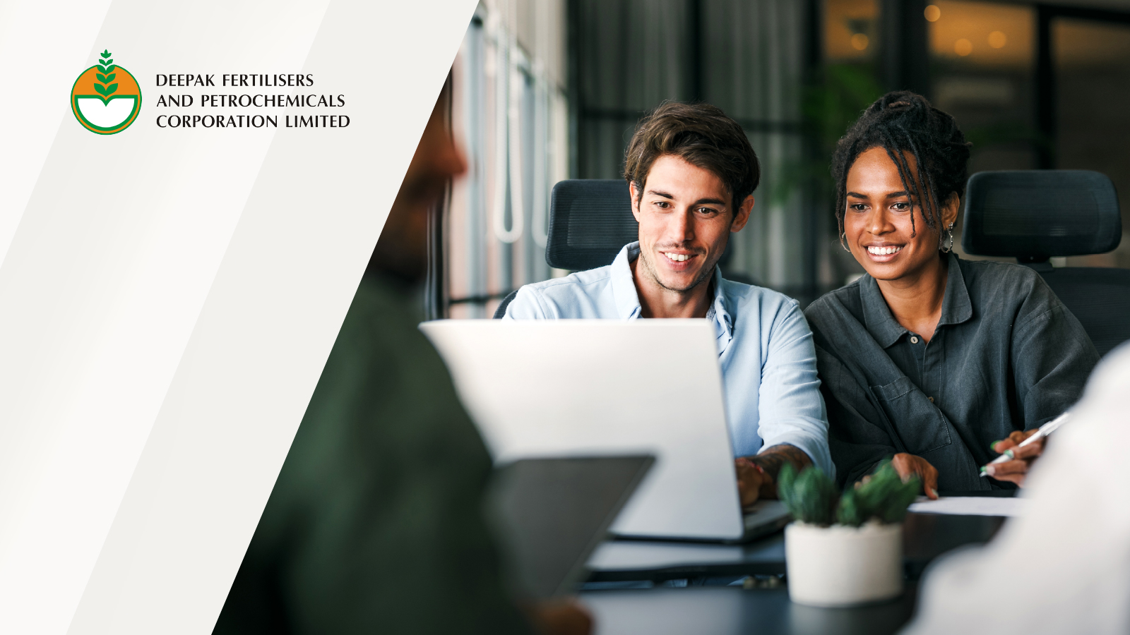 Deepak Fertilisers and Petrochemicals Corporation Limited logo displayed on the left with an image of two professionals collaborating and reviewing a laptop in a meeting setting.