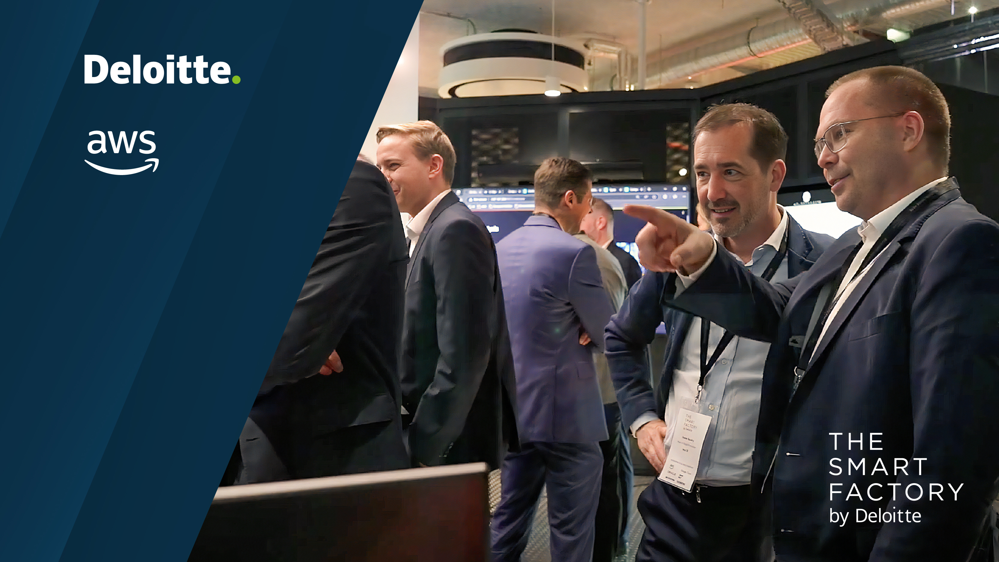 Deloitte and AWS logos displayed on the left side with “The Smart Factory by Deloitte” logo on the lower right. The image shows professionals in conversation at an event inside a modern industrial space.