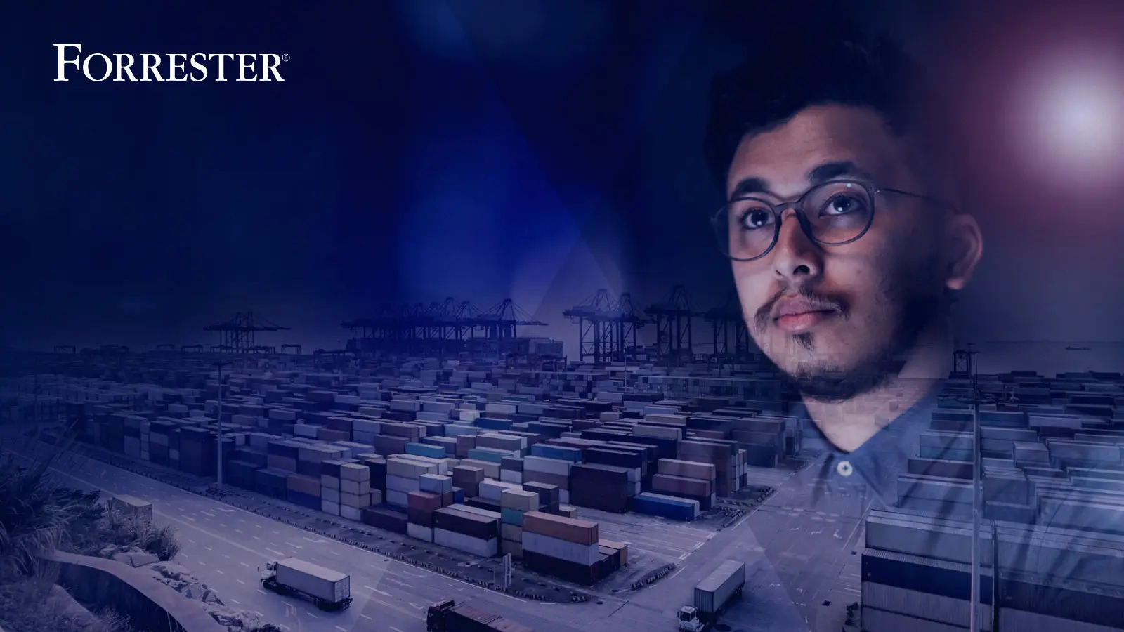 Man with glasses overlooking a shipping yard