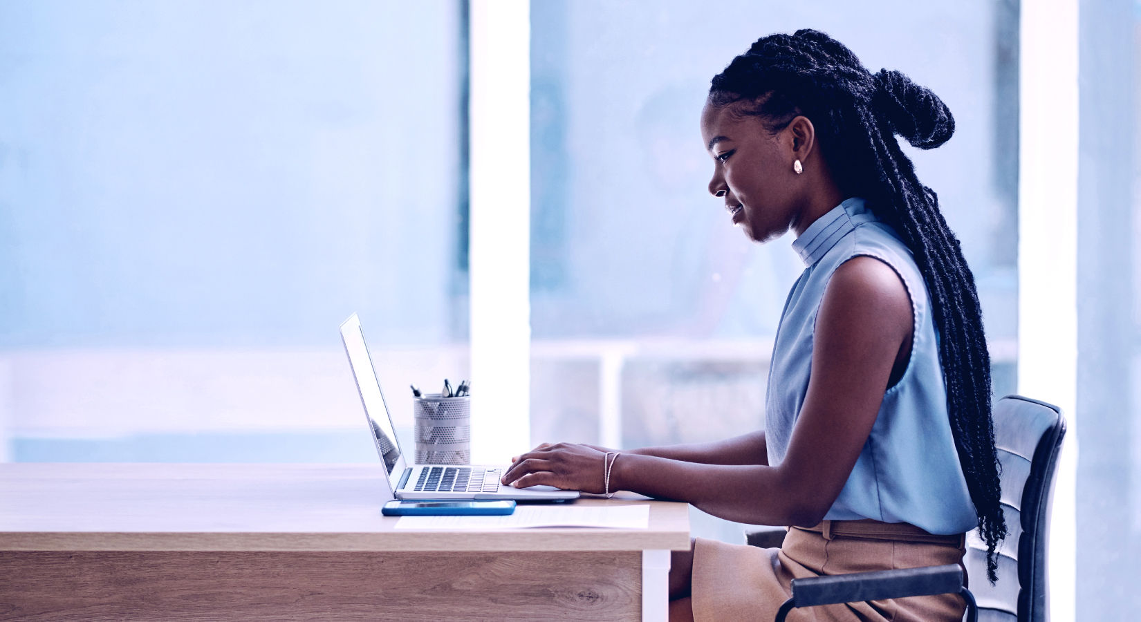 Talent Builder Independent Image Woman working on laptop in office setting