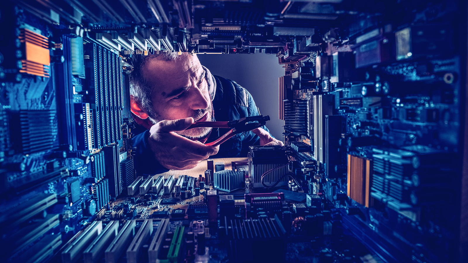 Man working on the inside of a machine/computer