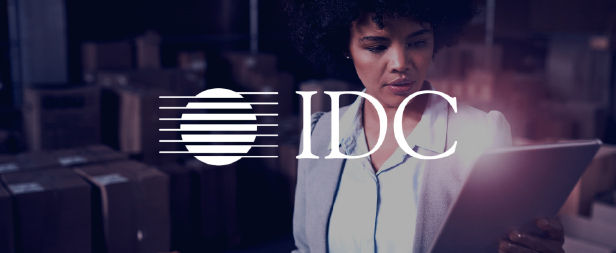 IDC Logo over image of woman reading on a tablet