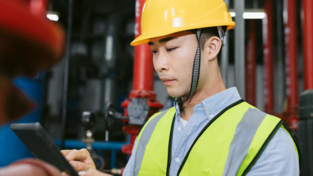 Man wearing a hard hat in a factory