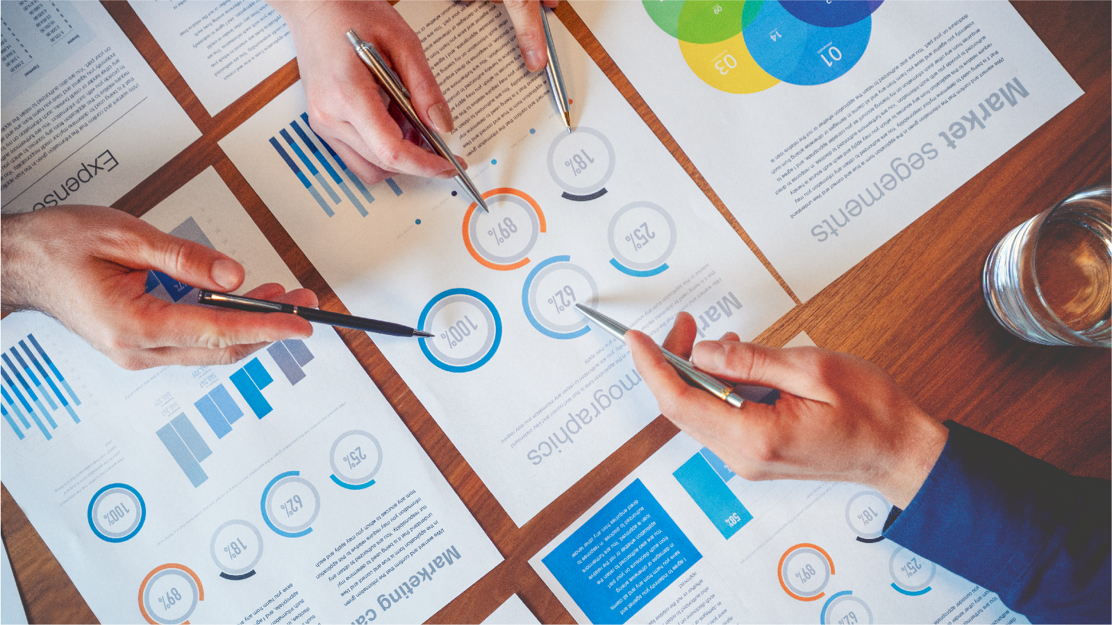 People examining papers with charts and graphs