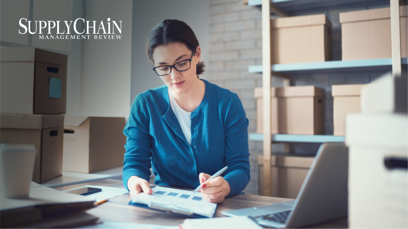 Woman working at desk in warehouse